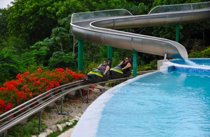 two women enjoying a bobsled ride down Mystic Mountain