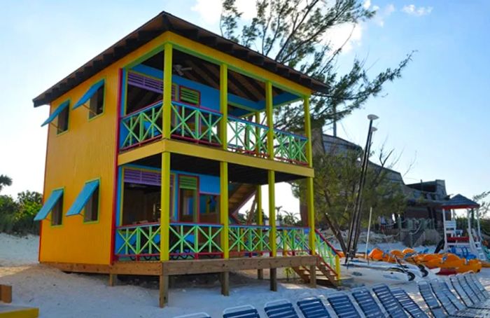 a yellow beach villa nestled in Half Moon Cay, The Bahamas