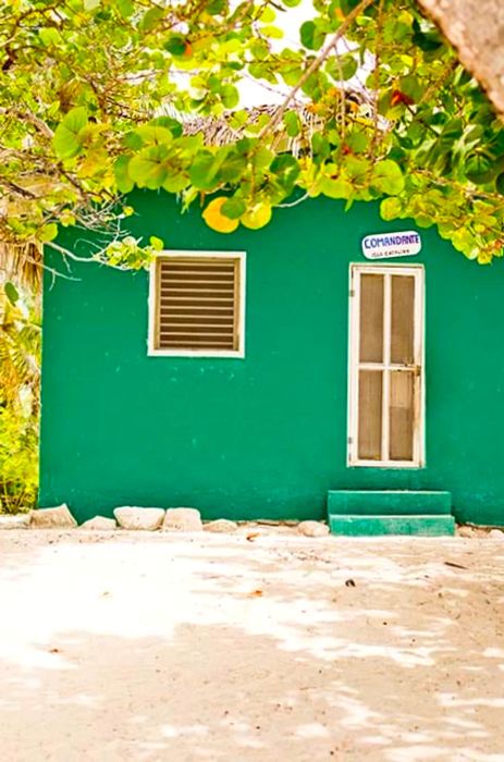 A green hut by the shore