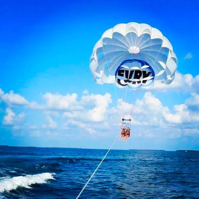 two individuals parasailing off the coast of Key West