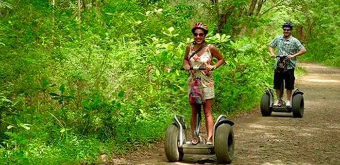 a man and woman enjoying a segway ride on a rugged trail in St. Lucia