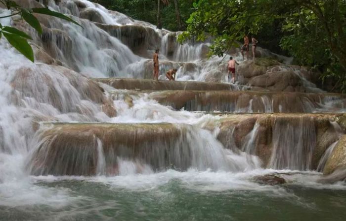 Visitors scaling Dunn’s River Falls in Jamaica