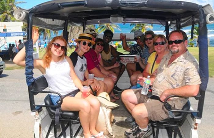 group of people seated in the back of a 4x4 truck before embarking on a tour of Barbados