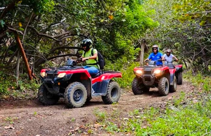 three men navigating an ATV through the secret trails of Amber Cove