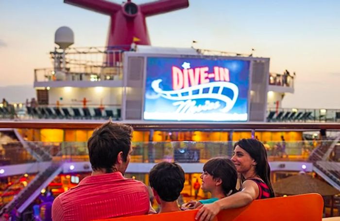 a family eagerly preparing to enjoy a dive-in movie at the Dinogo seaside theater