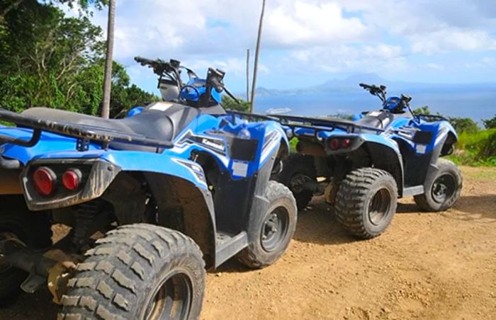 two ATVs parked along a dirt road in St. Kitts