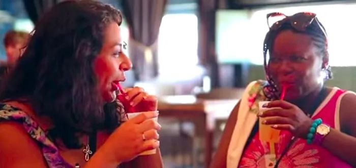 two women enjoy cocktails during a pub crawl in Key West