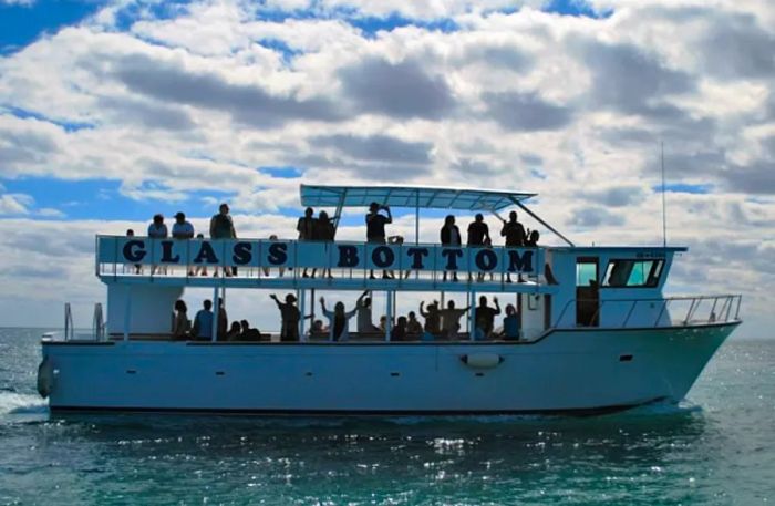 people waving from a glass-bottom boat in Freeport