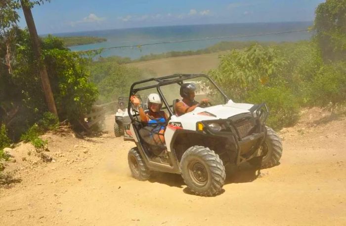 Couple enjoying a thrilling ATV ride up a hill in Montego Bay