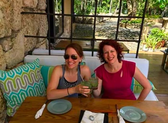 Rachelle and her friend enjoying drinks while relaxing at a table in La Cantina.