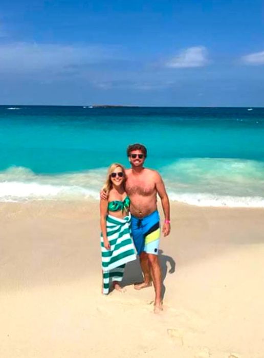 A mid-shot of a couple relaxing on the beach in Nassau