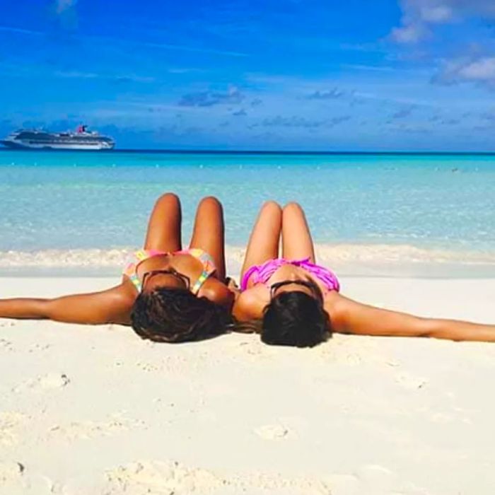 Two friends lounging in the sun at Half Moon Cay