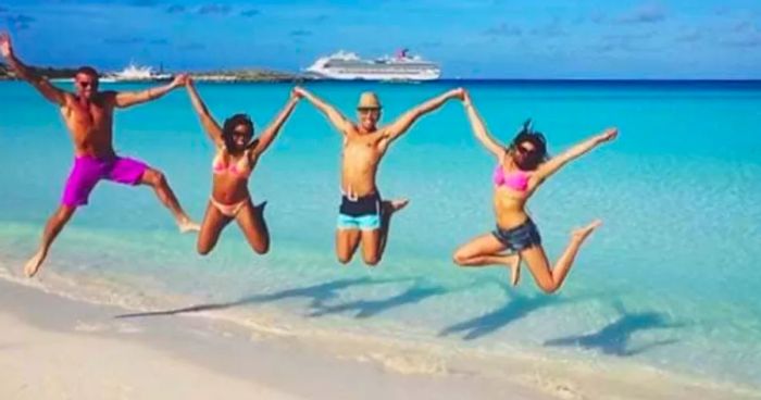 Four friends leaping for joy at Half Moon Cay