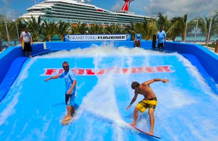 two surfers riding the FlowRider in Grand Turk