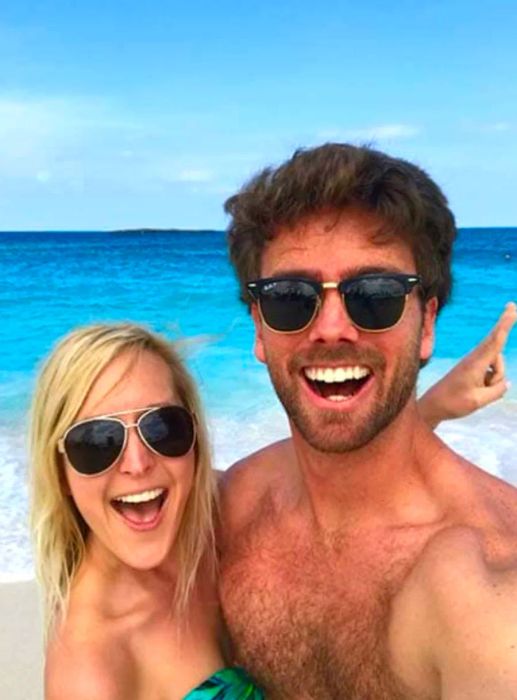 A couple relaxing on the beach in stylish sunglasses