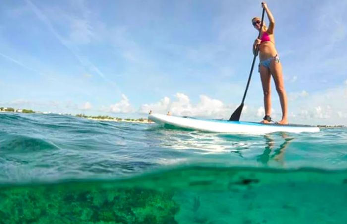 a woman paddleboarding in Grand Turk