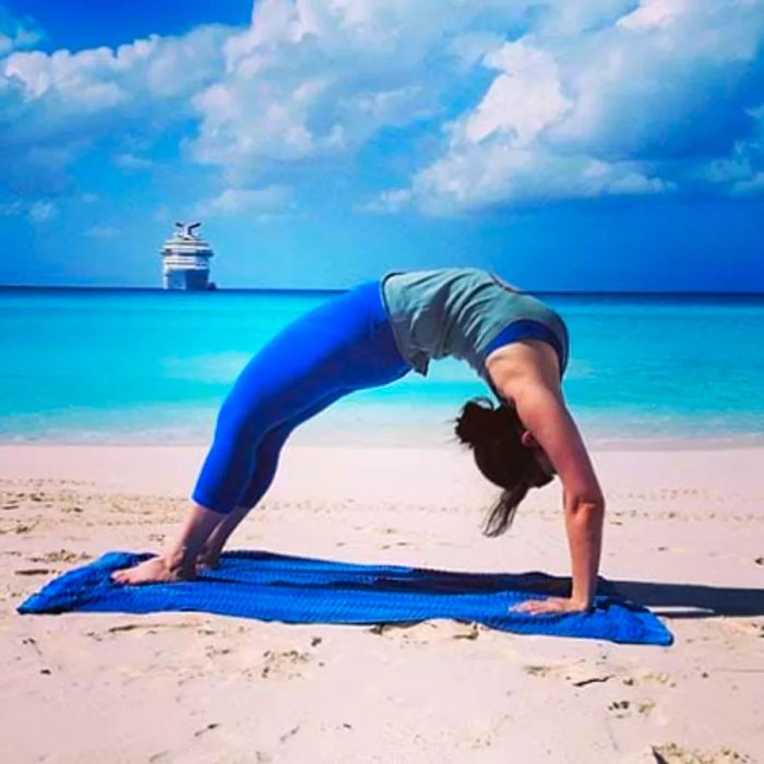 Practicing beach yoga in Half Moon Cay