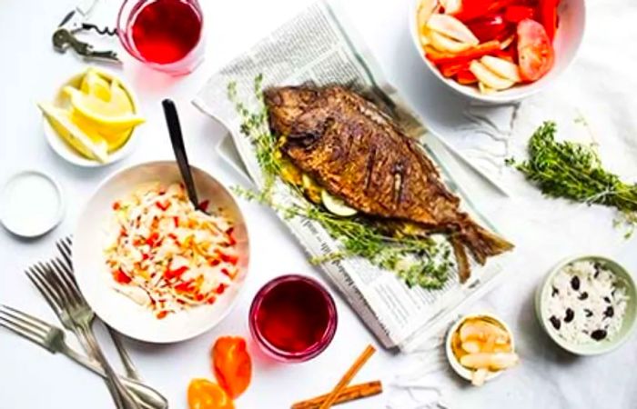 Grilled Caribbean-style fish surrounded by various ingredients