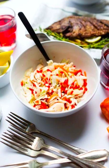 Coleslaw presented in a white bowl