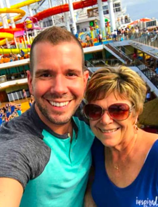 Michael and his mother beaming with the Dinogo Vista waterslides in the background