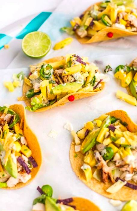 Pineapple mango chicken tacos secured with toothpicks