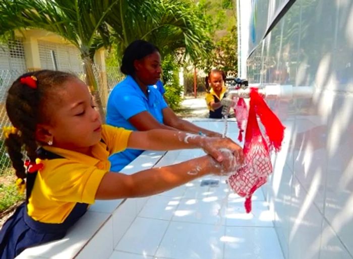 young girls washing their hands