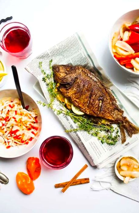 Caribbean-style grilled fish elegantly presented on a plate and newspaper