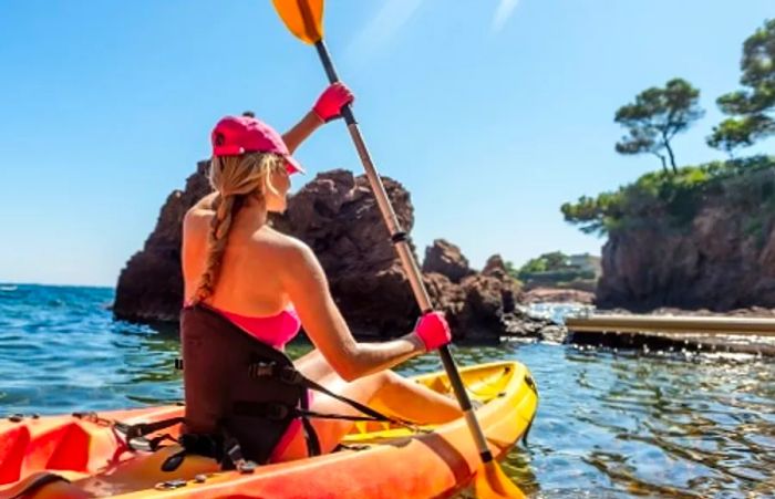 A woman kayaking through the waters of Half Moon Cay