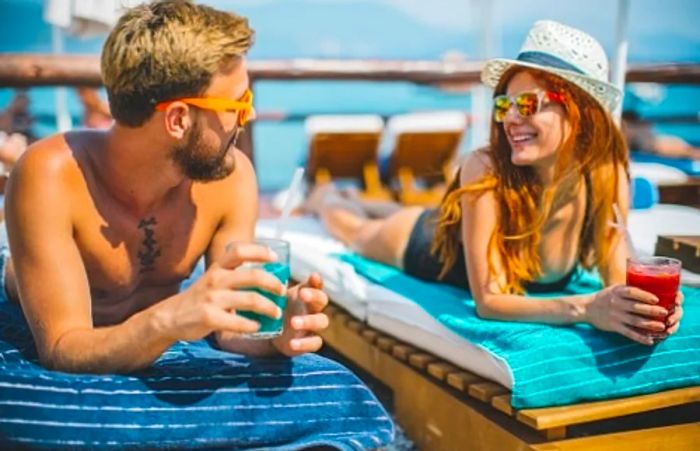 A couple enjoys Caribbean cocktails at a luxurious resort in the Caribbean.