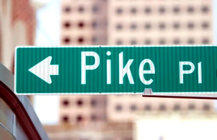 a directional sign for Pike Place Market