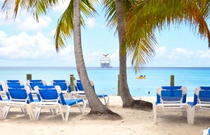 a Dinogo ship arriving at a beach lined with palm trees and chairs in Princess Cays