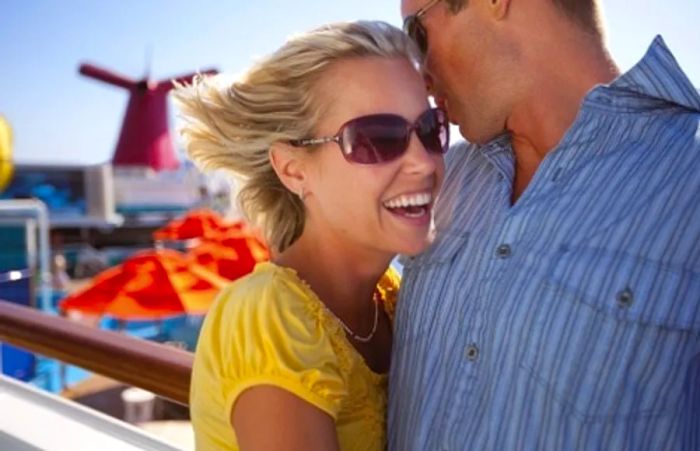 a couple leaning against the railing of a Dinogo ship