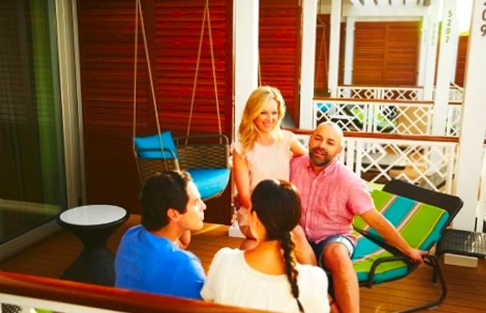 friends chatting on a stateroom balcony