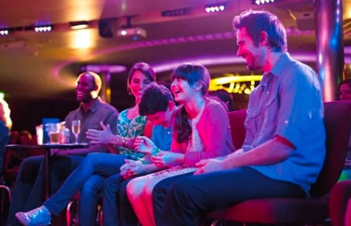 a family of four sharing a hearty laugh at the Punchliner Comedy Club