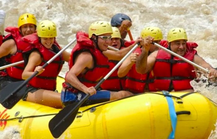 a group of adventurers whitewater rafting in Limón