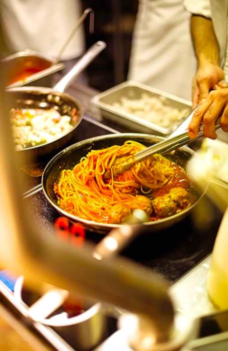 chef crafting spaghetti and meatballs