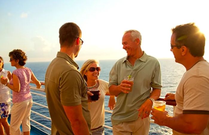 friends enjoying drinks on a cruise deck as the sun sets