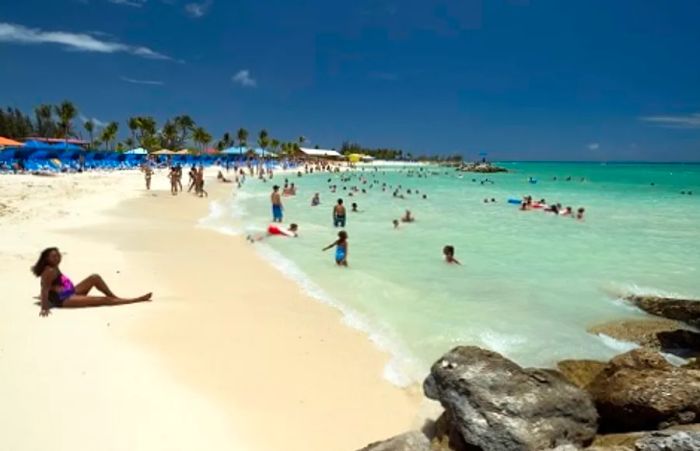 visitors sunbathing and swimming in the ocean at Princess Cays, Bahamas