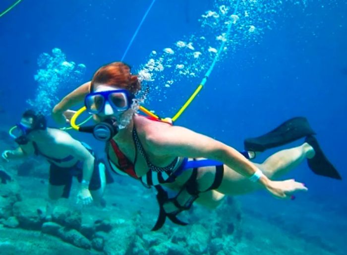 woman participating in a snuba diving shore excursion in The Bahamas