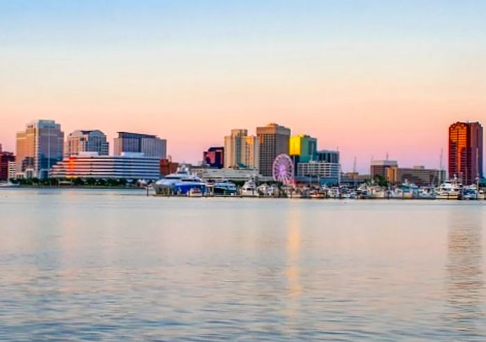 View of the Norfolk skyline across the water at sunset