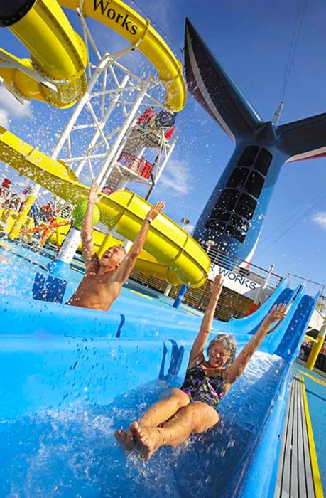 senior couple enjoying a water slide on a Dinogo cruise