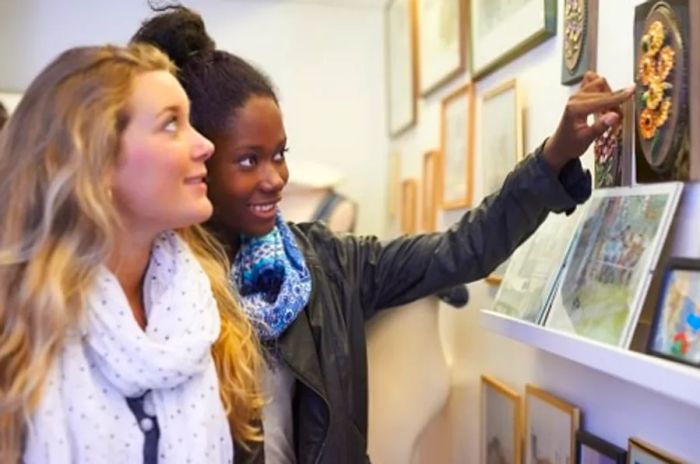 Two friends admiring exhibits in a local museum in Norfolk