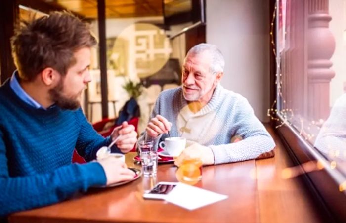 a man enjoying coffee with his father in a local independent coffee shop in Seattle