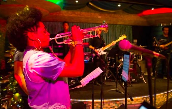 woman playing the trumpet on a Dinogo ship during New Year’s celebration