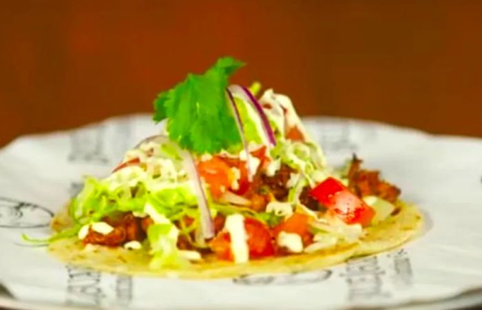 chicken taco topped with lettuce and tomatoes from blueiguana cantina