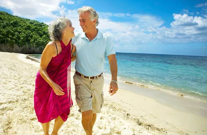 senior couple strolling along the beach