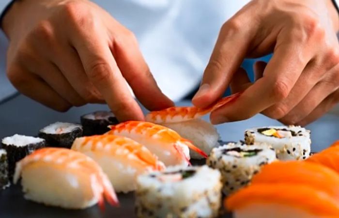 a chef crafting Japanese sushi rolls in a Seattle eatery