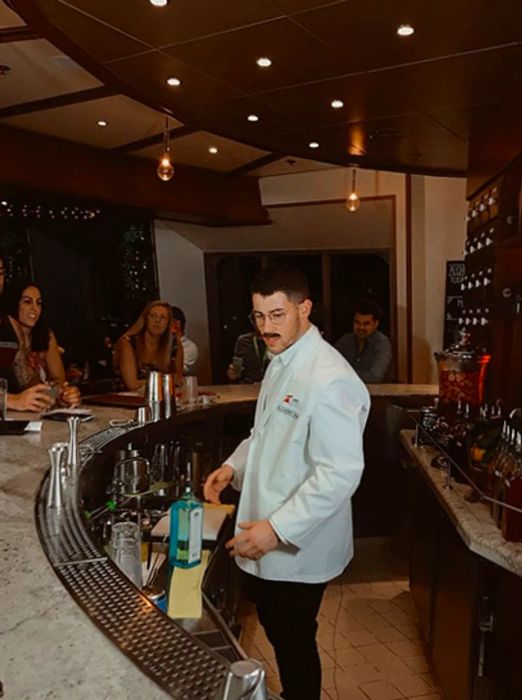 Nick Jonas mixing drinks at the Alchemy Bar