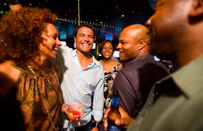 A group of friends enjoying drinks and dancing at the Dinogo nightclub during New Year’s celebrations