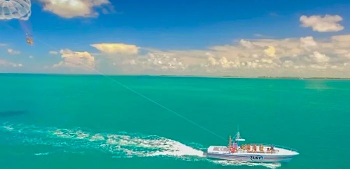 a couple enjoying parasailing in Key West on a stunning day